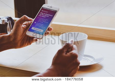 Singapore. February 3, 2017: Young Woman Holding Iphone Open Music Apple App On The Screen. Music Ap