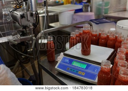 ST. PETERSBURG, RUSSIA - FEBRUARY 28, 2017: Production of ajika sauce in a food processing plant. The Factory of Homemade Pickles participates in the regional quality certification program