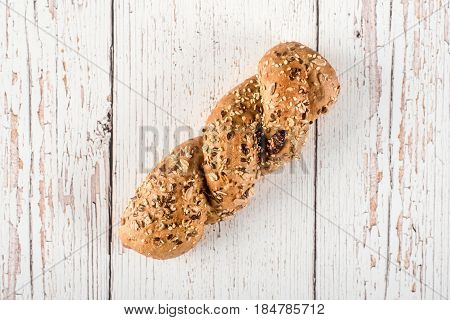 Fresh Seedy Bread On White Wooden Background