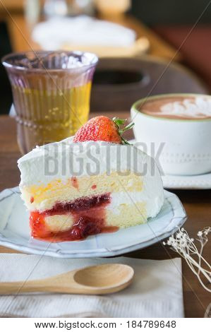 coffee cup and delicious cake strawberry and relax time moblie on table in coffee shop