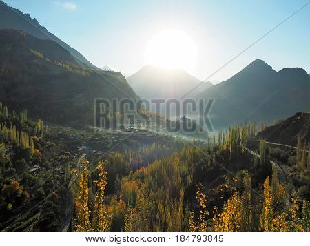 Landscape Of Golden Autumn In Hunza Valley And Altit Fort With Surrounding Mist, Karimabad, Gilgit-Baltistan Region Of Pakistan