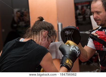 CRACOW POLAND - FEBRUARY 12 2016: Agnieszka Niestoj - talented Polish boxer durning boxing training with coach in the gym. Cracow Poland