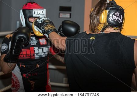 CRACOW POLAND - FEBRUARY 12 2016: Agnieszka Niestoj - talented Polish boxer durning boxing training with coach in the gym. Cracow Poland