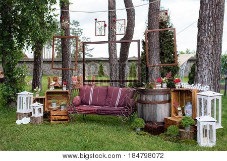 Beautiful Wedding Ceremony Outdoors. Decorated Chairs Stand On The Grass. Wedding Arch Made  Flowers