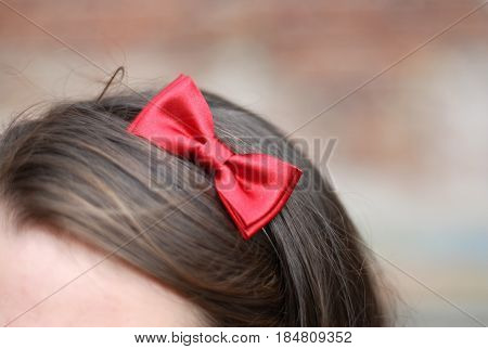 girl with red bow tie in hair
