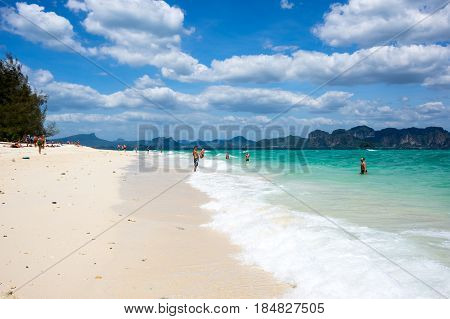 CRABI PROVINCE THAILAND - FEBRUARY 02 2015: Tourists relaxing on the white sand beach of Andaman sea at Krabi province Thailand