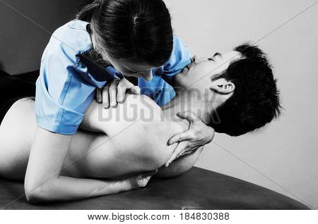 Physiotherapist Doing Manipulation To Man Patient In Silhouette Studio. Osteopathy.