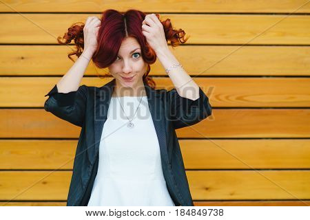 Portrait Of A Girl With Red On A Wooden Wall Background