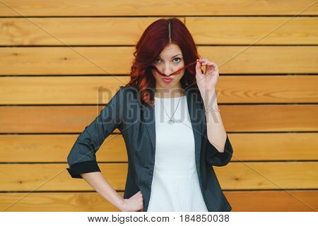 A Girl Makes A Mustache Out Of Her Hair