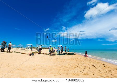 SRI LANKA - Mach 23: Local fishermen pull a fishing net from Indian Ocean on Mach 23, 2017 in Kosgoda, Sri Lanka. Fishing in Sri Lanka is the way they earn their living.