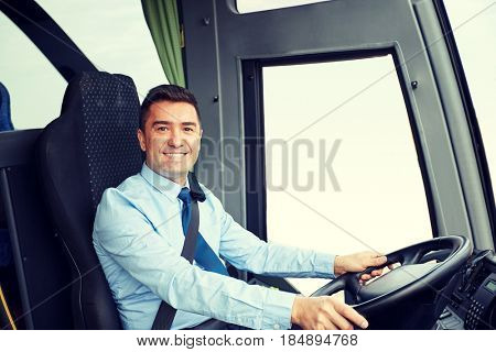 transport, tourism, road trip and people concept - happy driver driving intercity bus