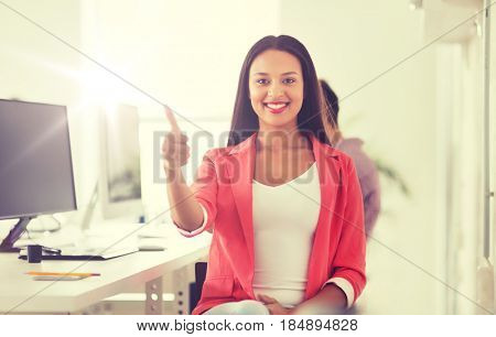business, startup, gesture, success and people concept - happy young african woman with computer working at office showing thumbs up
