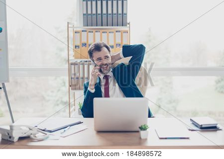 Happy Businessman Is Talking On His Phone, Relaxed And Smiling. He Is In Suit With Tie And Wearing G