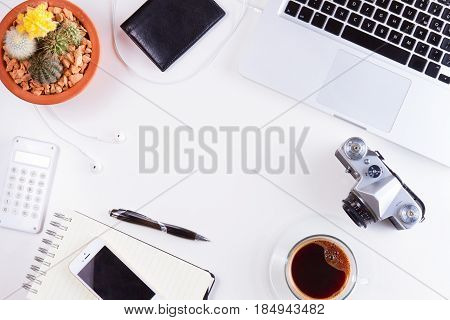 Styled workspace with laptop, phone, notebook and coffee, flat lay top view frame