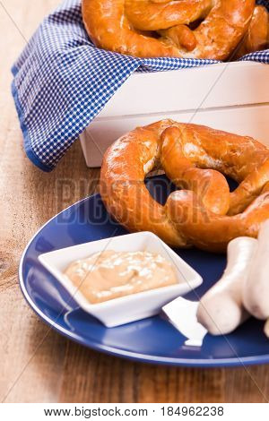 Bavarian pretzels with saisages on cutting board.