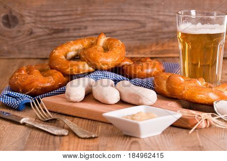 Bavarian pretzels with saisages on cutting board.