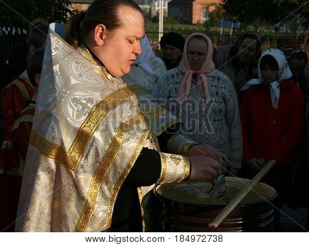 VOYUTYN UKRAINE - 14 OCTOBER 2008: Orthodox priest blessing of water during the religious celebration Pokrov