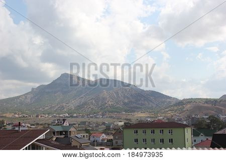 Russia. Crimea for travelers. Landscape blue sky with clouds, mountains, residential buildings