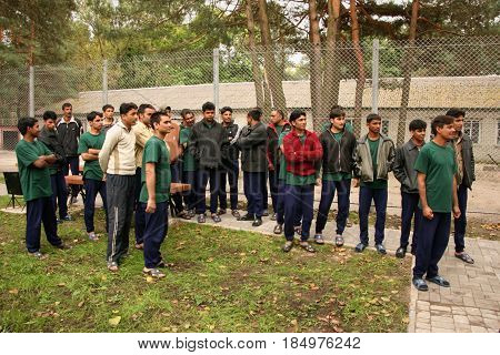 ZHURAVYCHI UKRAINE - 12 September 2008: Unknown men from Pakistan near fence at camp for temporary residence of foreigners and stateless persons who illegally stay in Ukraine