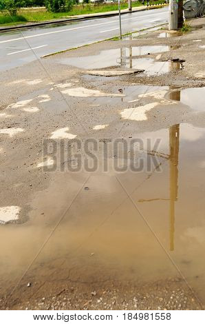 Reflection In Large Puddle On An Overcast Day
