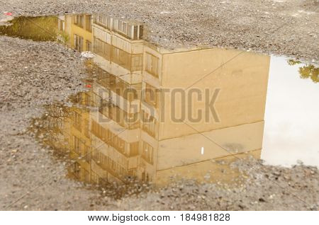 Reflection In Large Puddle On An Overcast Day