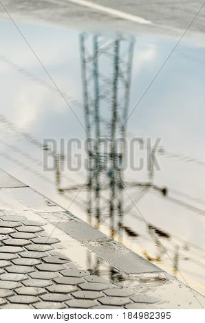 Reflection In Large Puddle On An Overcast Day