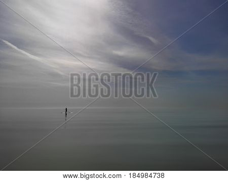 Picture of the calm sea and surfer.