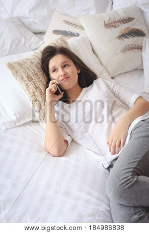 Pretty teenage girl talking on phone about her intimacy secret