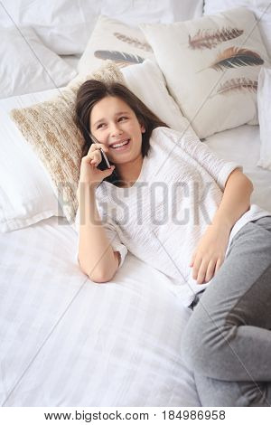 Pretty teenage girl talking on phone about her intimacy secret