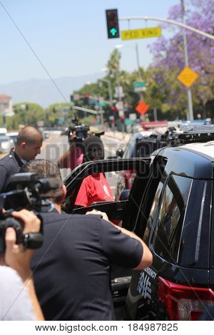 LOS ANGELES California- May 1, 2017: A person in a Black Ski Mask is arrested and put in a police car at a Protest Rally Against President Donald J.Trump on May 1, 2017 in Los Angeles, California
