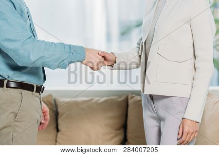 Cropped Shot Of Psychotherapist And Patient Shaking Hands In Office