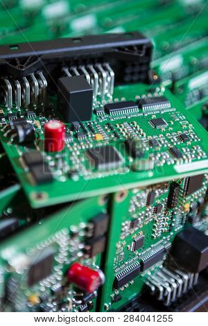 Batch Of Ready Automotive Printed Circuit Boards With Surface Mounted Components. One Pcb Lying On T