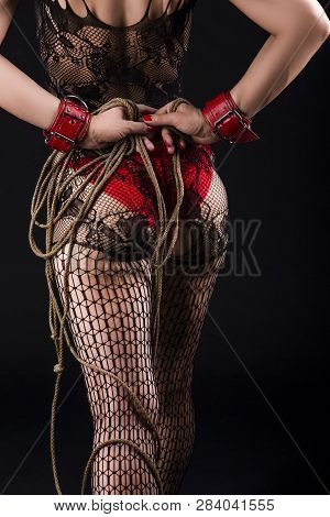 Bdsm Ideas. Female In Bdsm Sexy Lingerie Posing With Rope Accessories For Bdsm Play. In Red Handcuff