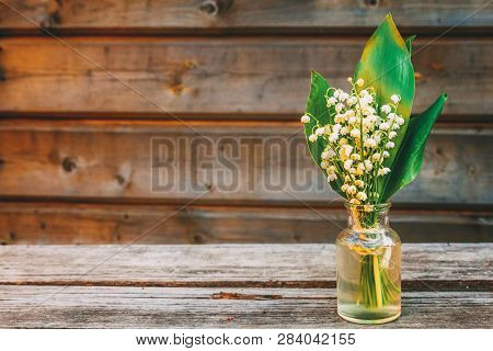 Bouquet Of Flowers Beautiful Smell Blossom Twigs Lily Of The Valley Or May Lily In Glass Vase On Rus