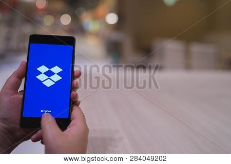 Chiang Mai, Thailand - April 4,2018: Woman Holding Huawei With Dropbox On Screen. Dropbox Is A Servi