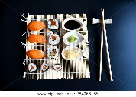 Close Up Top View Mix Sushi With Various Ingrediant As Salmon, Tuna, Avocado,sesame On Black Backgro