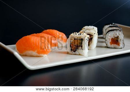 Close Up Top View Accessories With Chopstick And Small Plate With Sauces For Sushi On Black Backgrou