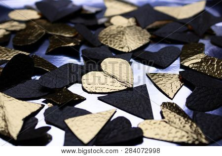 Black And Yellow Paper Hearts And Triangles On The Blue Background