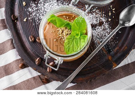 Chocolate Coffee Pudding Or Mousse With Halvah And Mint In A Jar. Overhead Shot.