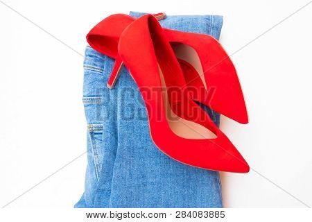High Heel Red Shoes On Heels With Blue Jeans On White Background