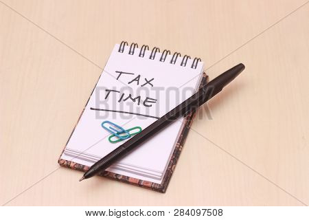 Illustration For Tax Time, Block Note At Wooden Table