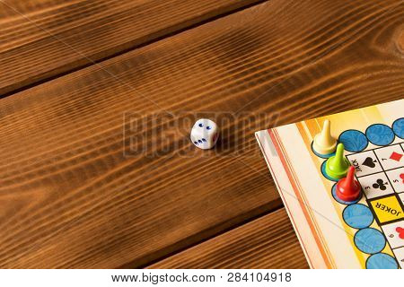 Multi-colored Game Chips With Dice On The Playing Board. Board Game Concept