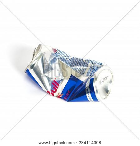Sankt-petersburg, Russia - December 27, 2018:  Crumpled Aluminum Can Of Redbull Drink Over White Bac