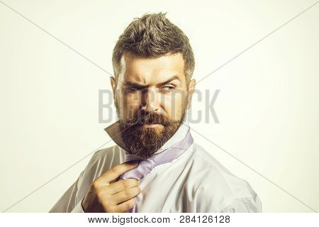 Bearded Handsome Businessman Fixing Tie On Neck. Man Adjusting Tie. Businessman Wearing Or Tighten N