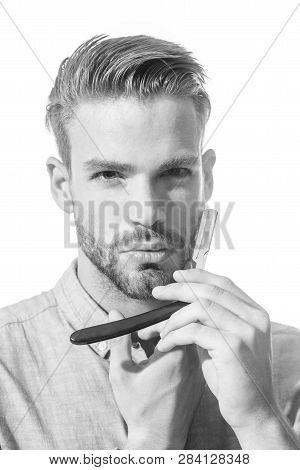 Bearded Stylish Hairdresser With Straight Razor For Shaving. Hairdresser In Denim Shirt Demonstratin