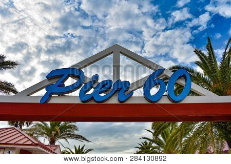 Clearwater Beach, Florida. January 25, 2019 . Top View Of Pier 60 Sign And Palms Trees On Lightblue 
