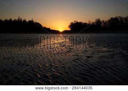 Background Pattern Of Seawave On Mud And Sunset In The Evening