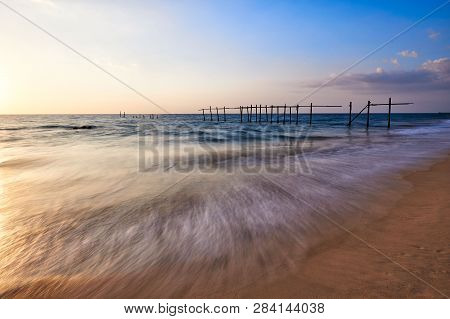 Beautiful Waves And Colored Sky During Sunset At Pilai Beach, Phang-nga Province, Thailand