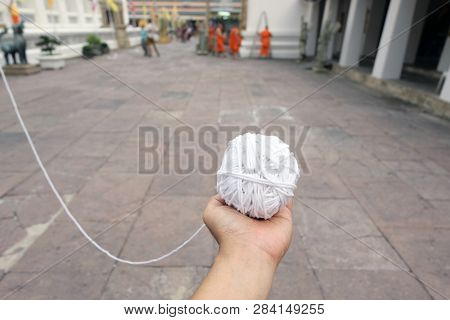Hand Holding White Sacred Rope Is A Symbol Of Prayer That Plays An Important Role In Buddhism And Th