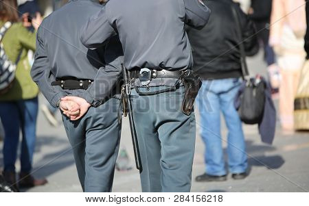 Two Cops With Uniform And Handcuffs In The City